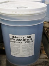 clear bucket, white lid, blue liquid, white label
